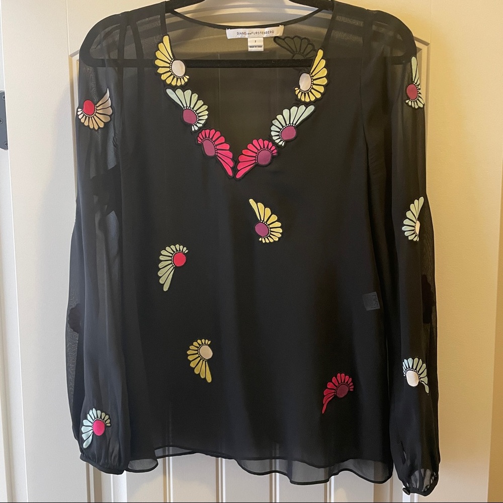 Diane von Furstenberg black sheer top with stitched floral design.